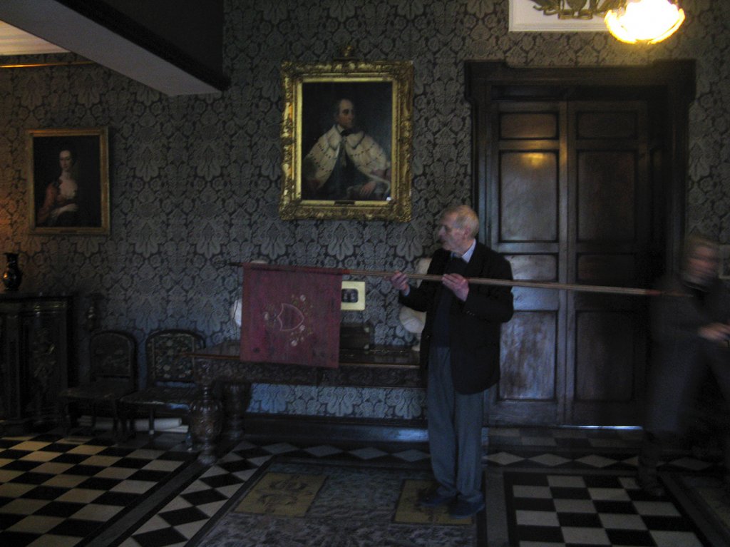 Egerton Shelswell-White holding the ancestral banner in front of The 1st Earl