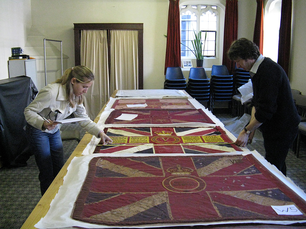 Surveying the condition of the collection of Regimental Colours.