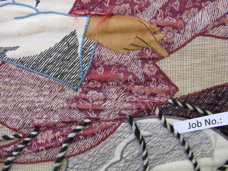 Detail of the worn fabrics of appliqué fabrics before treatment.