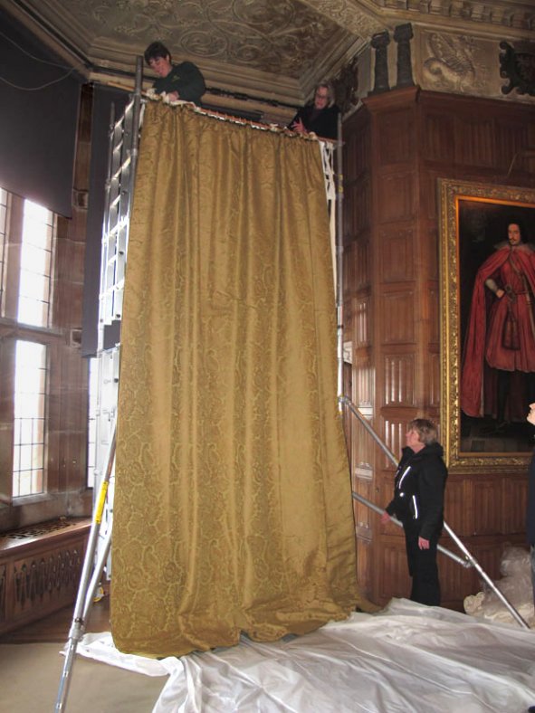 Using scaffolding to install the curtains