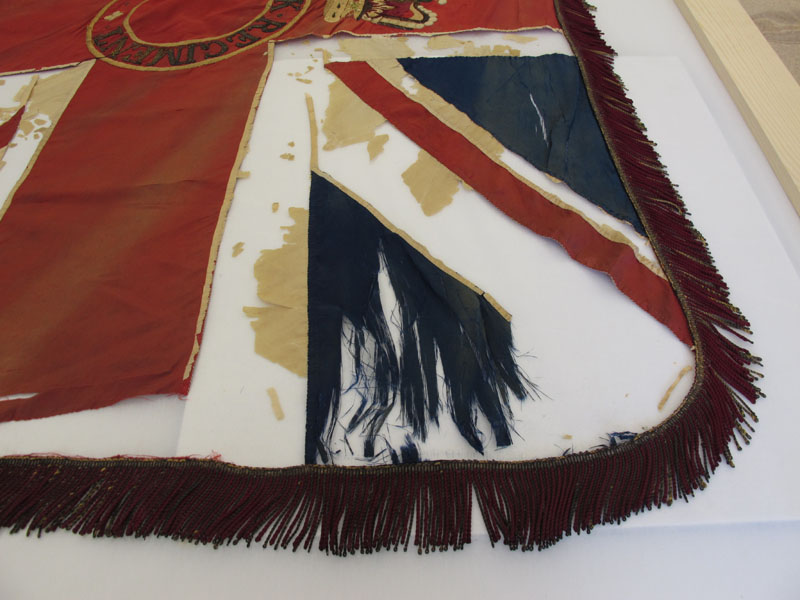 A detail of the Queen's Colour before wet cleaning