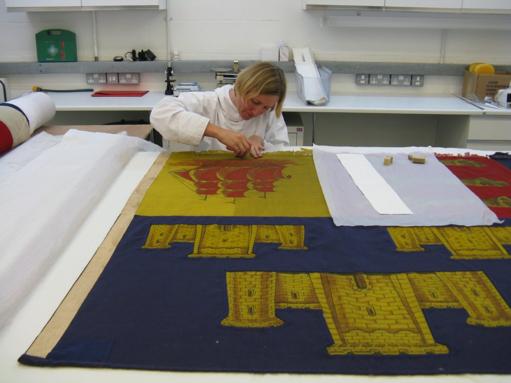 Gerda surface cleaning Churchill's Cinque Portes Standard with a sponge.