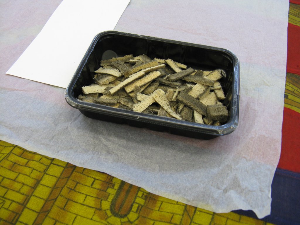 Pieces of sponge with the soiling that has been removed.