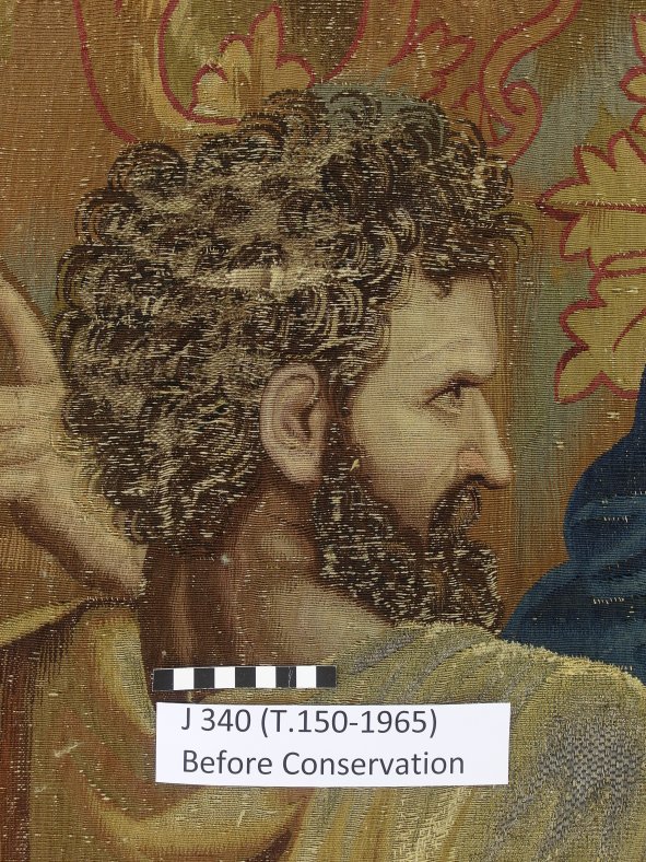 A detail of one of the faces before conservation treatment