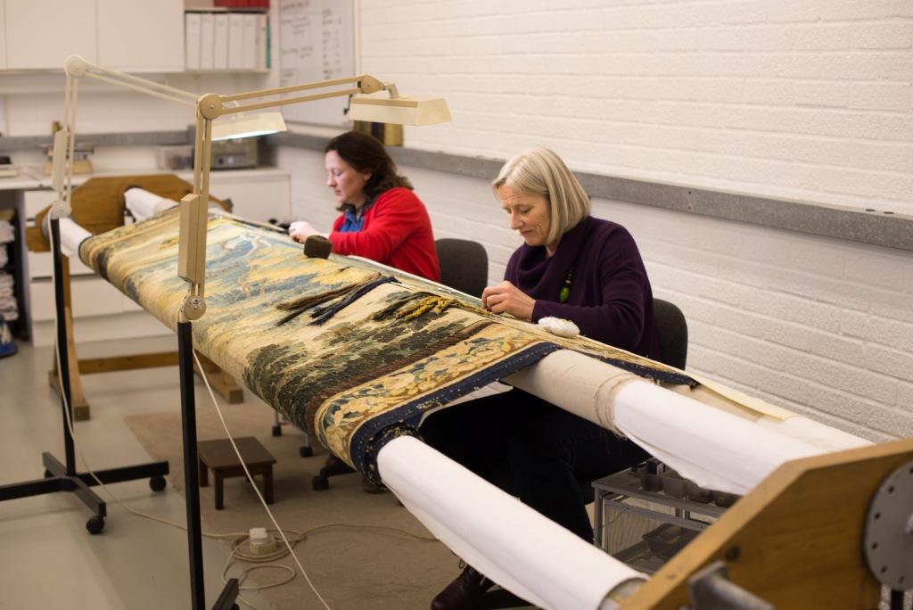 May and Anna stitching the tapestry on the frame